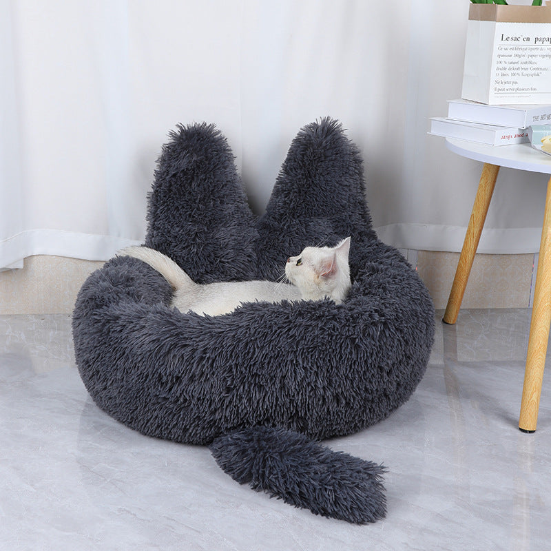 cat lying in dark grey cozy plush cat bed