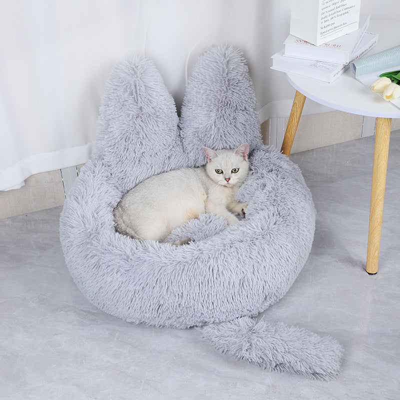 cat lying in light grey cozy plush cat bed 