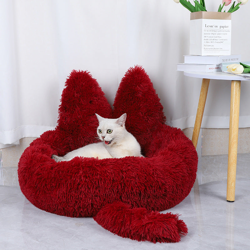 cat lying in red cozy plush cat bed 