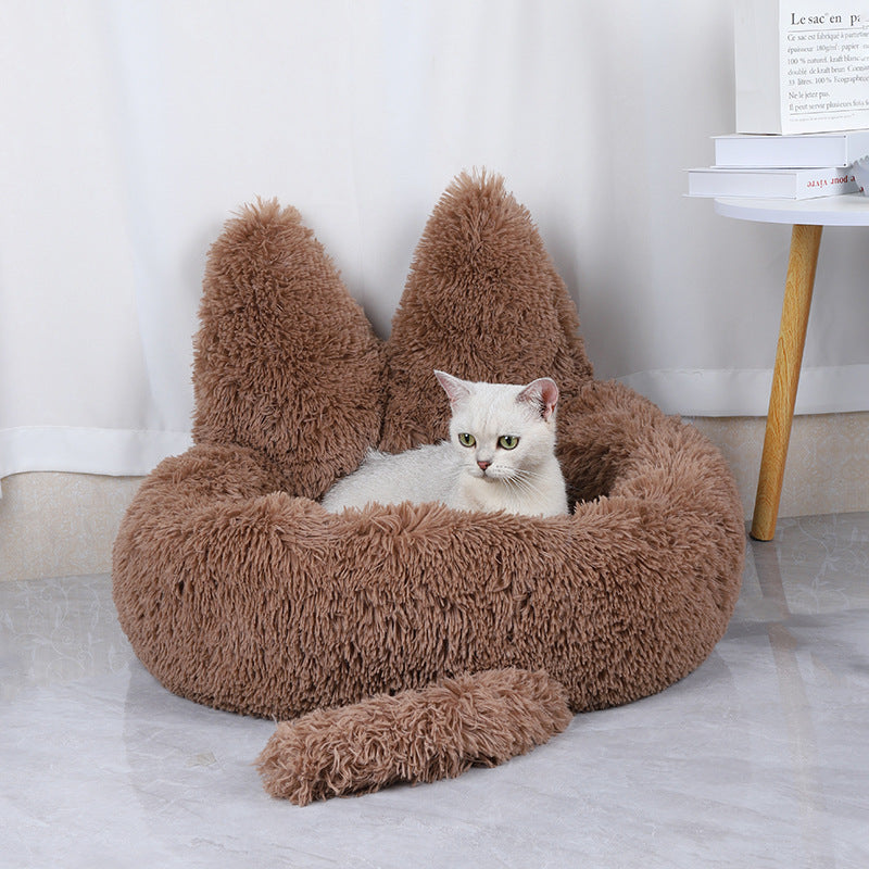 cat lying in light brown cozy fluffy cat bed 