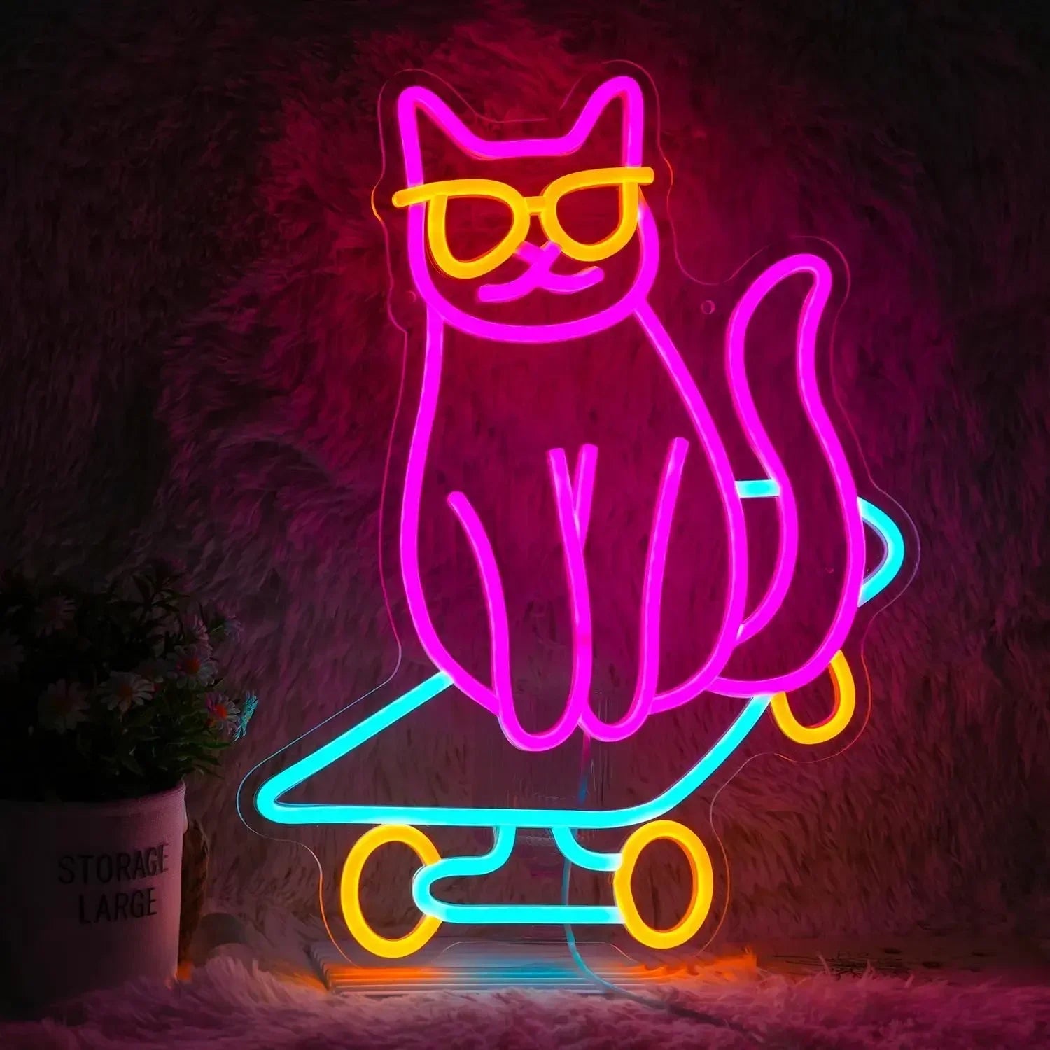 Neon sign featuring a cat wearing sunglasses and riding a skateboard, glowing in pink, blue, and yellow tones.