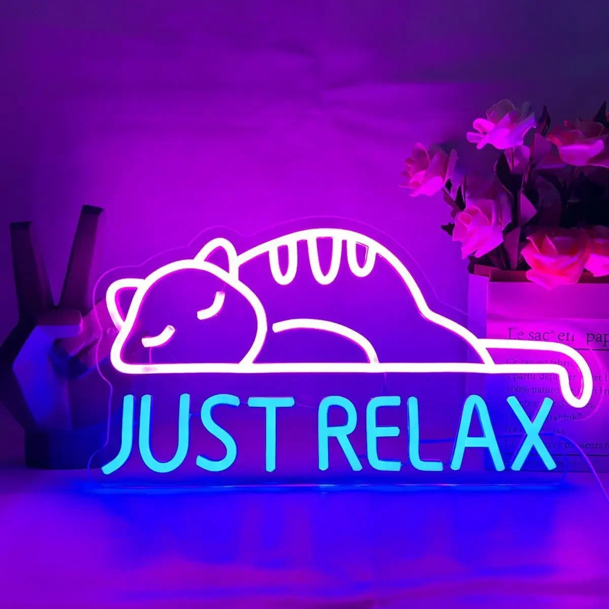 Purr-fect Snooze Neon Sign with a sleeping cat and 'Just Relax' text in vibrant pink and blue glow.