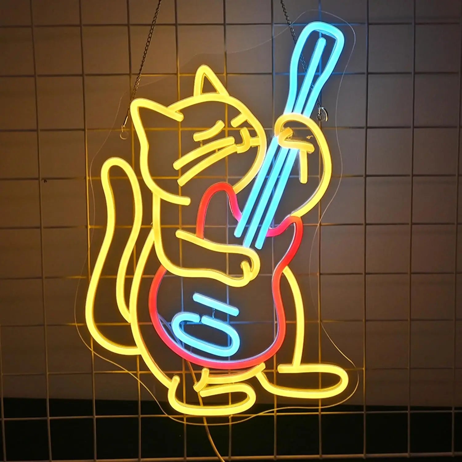 Neon LED sign of a cat playing a bass guitar, featuring vibrant yellow, blue, and red glowing lights against a grid background.